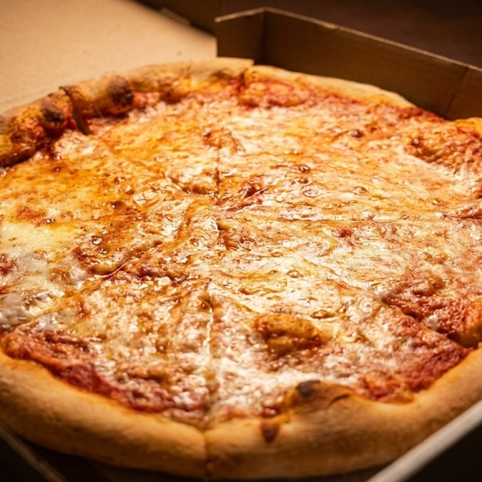 A whole, hot cheese pizza with a golden crust, sliced and sitting in a cardboard delivery box.