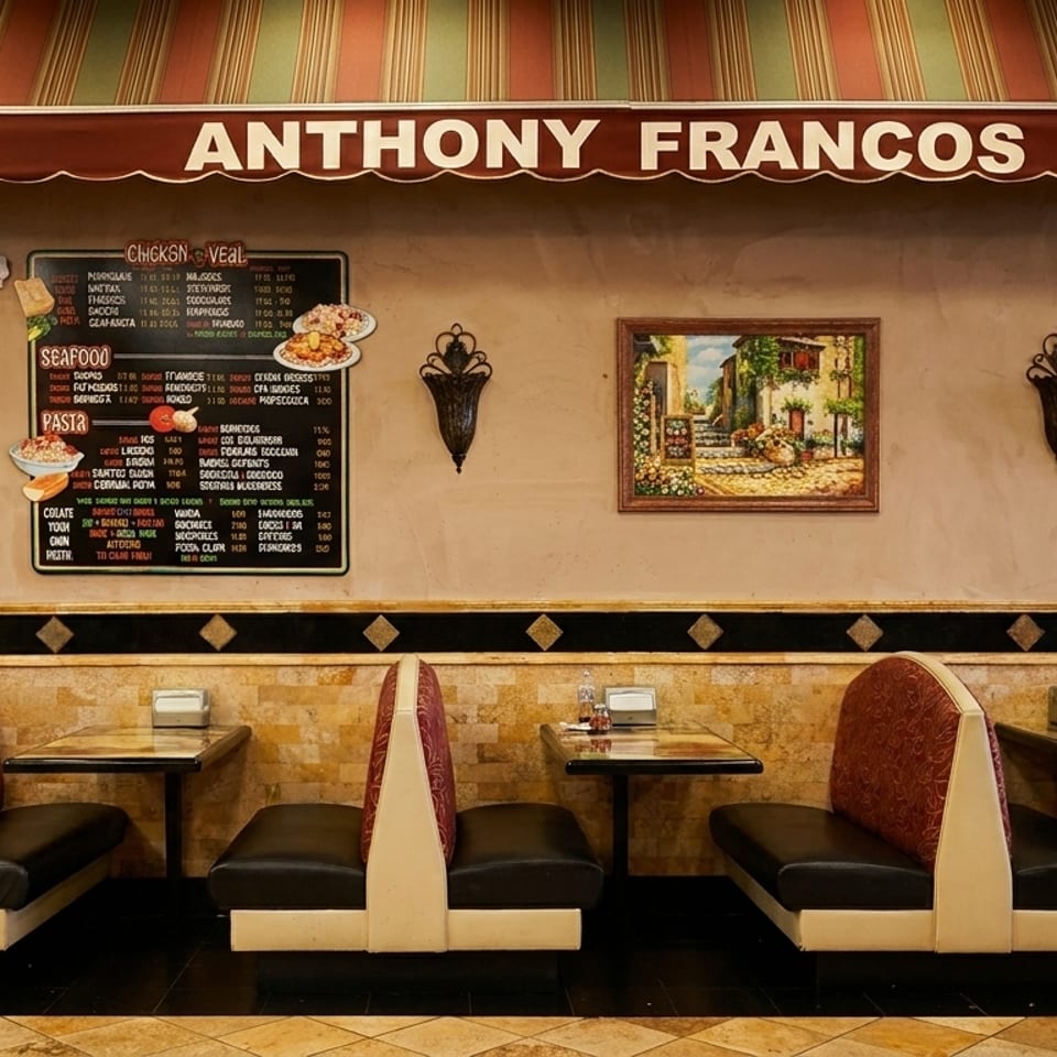 Interior of Anthony Franco's restaurant with booths, menu board, and framed art on the wall.